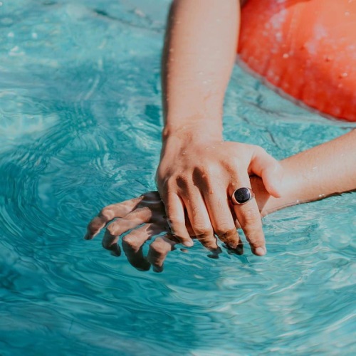 woman relaxes on a floatie in swimming pool