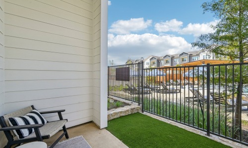 fenced in back patio with private yard